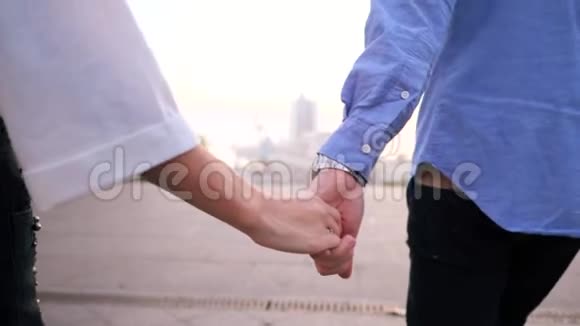 在秋天的街道上合上时髦的情侣手男人和女人牵着手一起跑年轻人在视频的预览图