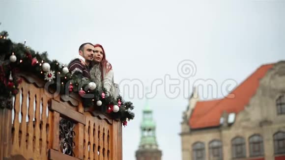 有几个情人在拥抱你自己圣诞节期间他们站在木制阳台上新年快乐视频的预览图
