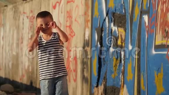 穿条纹衬衫的开朗的小男孩市区儿童散步视频的预览图