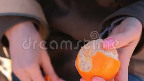 贴身女人她的手在公园里剥橘子视频的预览图