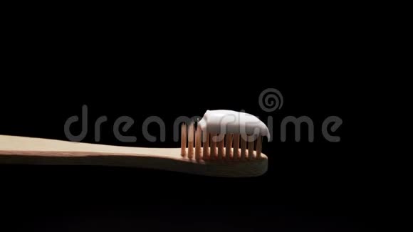 黑底白色牙膏的传统环保木竹牙刷视频的预览图
