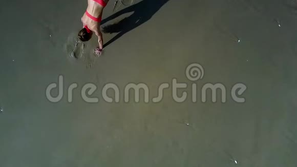 女性瑜伽姿势在海岸保持腿视频的预览图