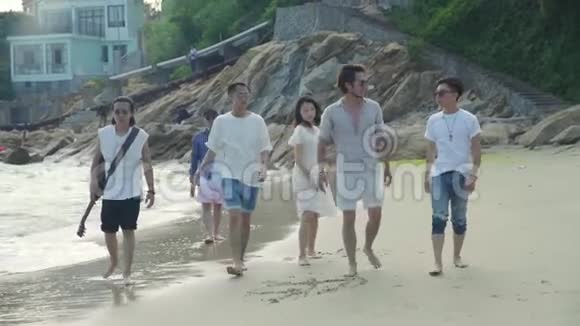 亚洲青年男女在沙滩上散步视频的预览图