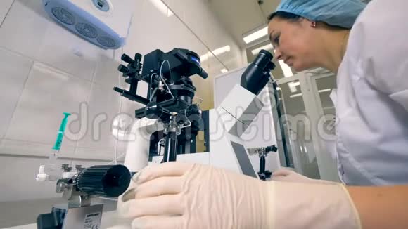 实验室工作人员校准显微镜的低视角视频的预览图