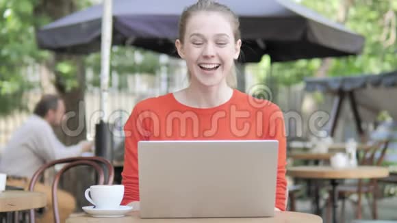 坐在咖啡厅露台上的年轻女子在线视频聊天视频的预览图