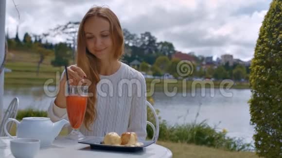 咖啡屋配有勺子的少女斯蒂尔斯冷橙饮料视频的预览图