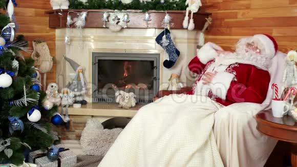 休息圣诞老人甜蜜的梦疲惫的老圣尼古拉斯在辛勤工作后打盹房间里有壁炉视频的预览图