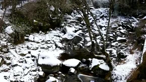 溪流流过白雪覆盖的岩石视频的预览图
