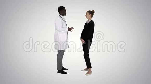 男性非洲医生在梯度背景下与女性患者交谈视频的预览图