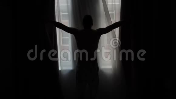 男人剪影移动窗帘从窗外看街视频的预览图