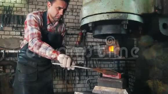 铁匠工作时用电锤靠近铁砧红热钢制造视频的预览图