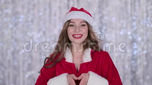 穿着雪少女红色西装的女孩送一个空气吻博克背景关门视频的预览图