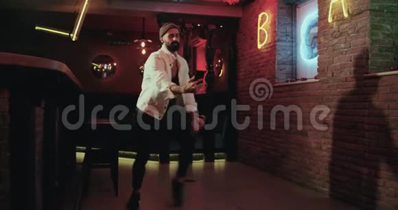 年轻人在酒吧跳舞用智能手机拍照视频的预览图