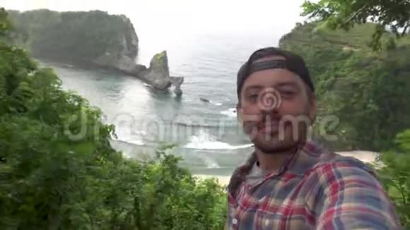 自私的男人旅行者在悬崖整洁的海洋上拍照佩奈达视频的预览图
