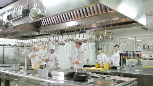 厨师在餐厅或酒店厨房的炉子上准备饭菜视频的预览图