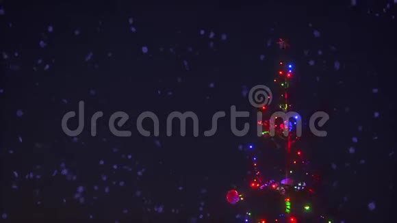 圣诞树的特写树枝五颜六色的花环被雪花动画包围视频的预览图