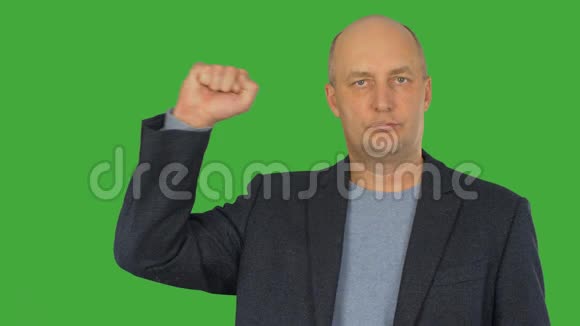 男人在绿色的彩色钥匙背景上右手握拳阿尔法通道按键绿色屏幕视频的预览图