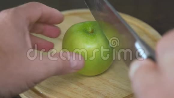 男人手把绿苹果切成两等份这些是维生素和健康的饮食视频的预览图