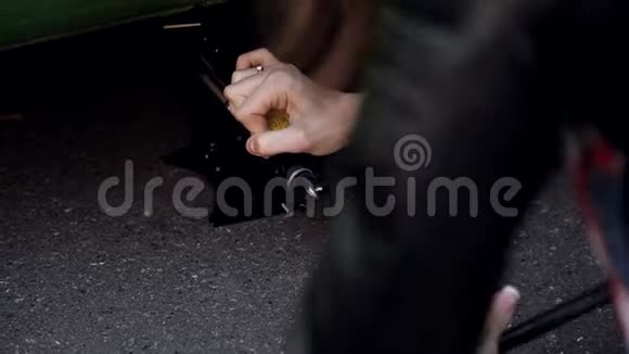 路边的女孩学着在他的汽车特写镜头上换轮胎视频的预览图