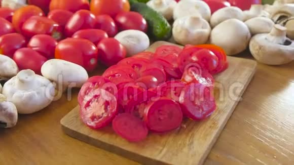 厨房桌子上的木板上的新鲜蔬菜和西红柿的特写相机旋转视频的预览图