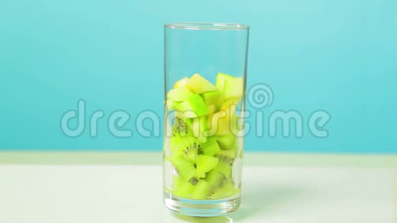 在一个玻璃玻璃片中切下一个猕猴桃和苹果的水果片玻璃旋转成一个圆圈视频的预览图