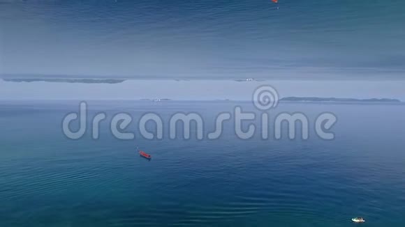 澄碧的海面上带着涟漪和落寞的红船镜面视界效果媒体美丽平静的海水视频的预览图