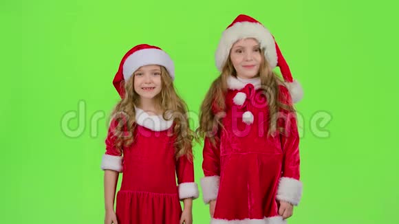 穿红色西装的孩子们站在房间里眨眼绿色屏幕慢动作视频的预览图