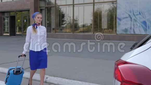 女机场工作人员在后台机场乘坐带旅行箱的白色汽车视频的预览图