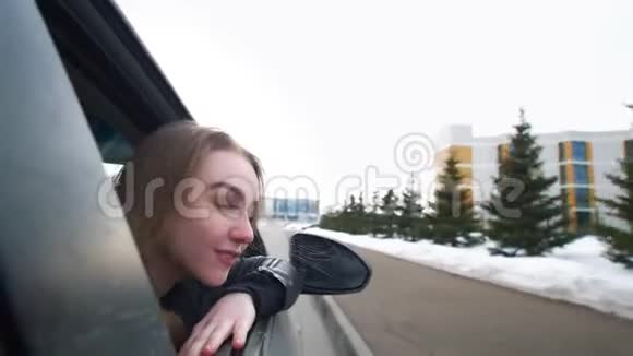 幸福的女人倚在车窗上欣赏着旅途视频的预览图