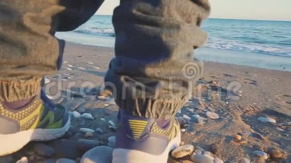 宝宝的生活方式在海边的海滩上特写运动鞋与斯泰西卡姆视频的预览图