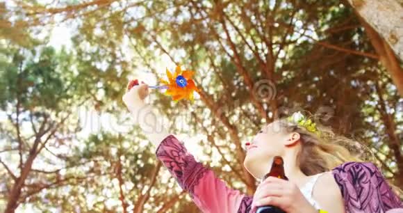 女人玩玩具风车和啤酒瓶4k视频的预览图