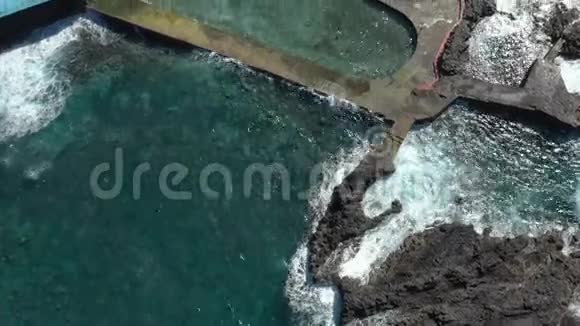 上景巨大的海浪在酒店泳池屏障上翻滚视频的预览图