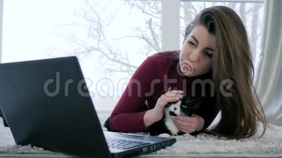 快乐的女人带着家养的动物在度假时用笔记本电脑休闲视频的预览图