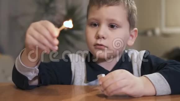 男孩拿着安全火柴看着火焰慢动作视频的预览图