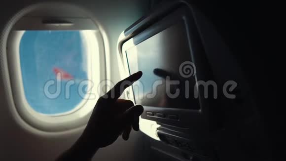 乘客在飞行过程中触摸飞机舱内的传感器屏幕特写镜头视频的预览图