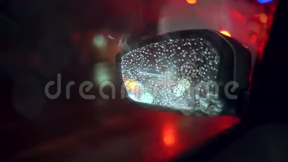 夜间下雨时在汽车后视镜上看到城市灯光视频的预览图