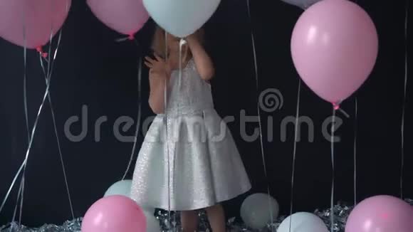 一个美丽的小女孩的画像微笑着手里拿着彩色气球里面有许多气球和一个视频的预览图