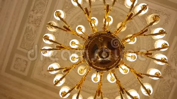 吊在天花板上的大型圆形金色古董吊灯视频的预览图