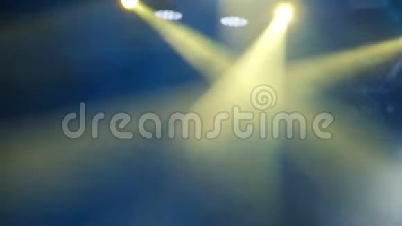 在岩石音乐会现场的烟雾中闪烁着蓝色和黄色的光模糊的背景镜头视频的预览图