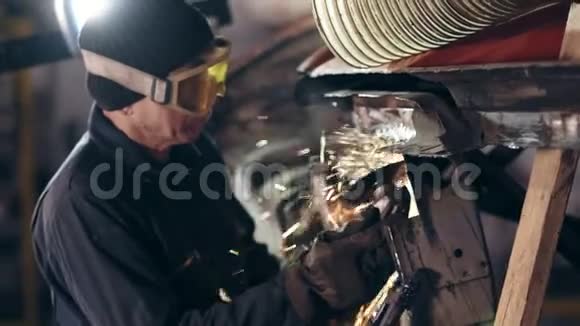 带防护眼镜的工人用圆锯打磨金属结构视频的预览图