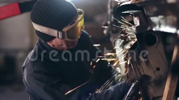 带防护眼镜的工人用圆锯打磨金属结构视频的预览图