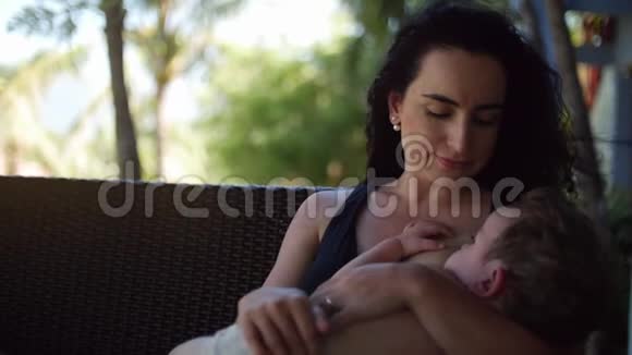 妈妈带着一个孩子在户外给他哺乳给一个蹒跚学步的孩子母乳视频的预览图