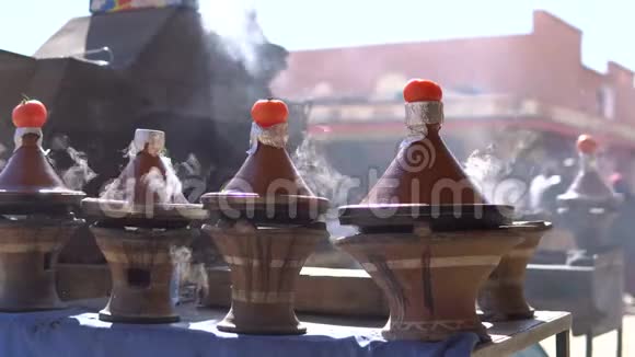 传统的摩洛哥塔吉纳食物在塔吉纳火锅里烹调上面有烟和西红柿视频的预览图
