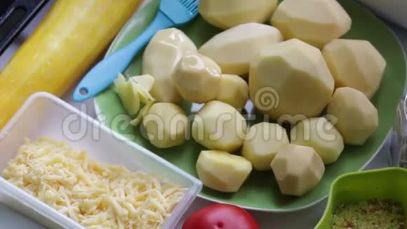 烹饪晚餐的配料桌子上摆着土豆西葫芦西红柿磨碎的奶酪和香料视频的预览图