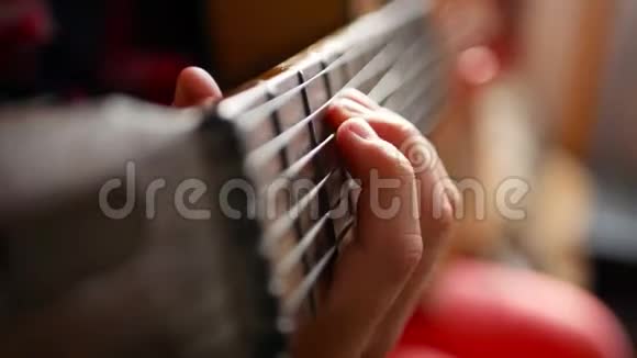在家弹吉他的少女把可爱的少年关在室内穿着一件帽衫轻轻地弹着吉他视频的预览图