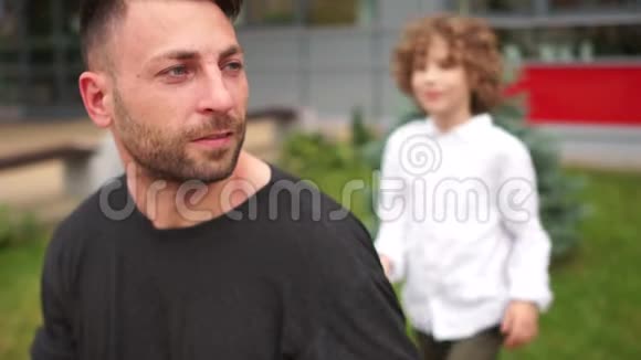 儿子拥抱他的父亲男孩高兴地笑了父亲的日子视频的预览图