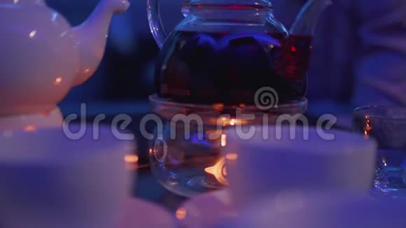 茶桌上放着茶杯的蜡烛加热茶壶视频的预览图
