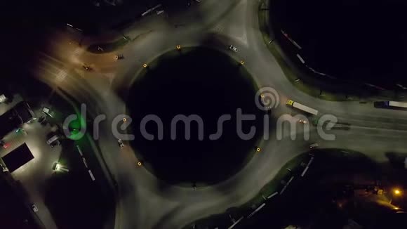 从俯视空中镜头看道路环形交叉路口的夜间车辆流量视频的预览图