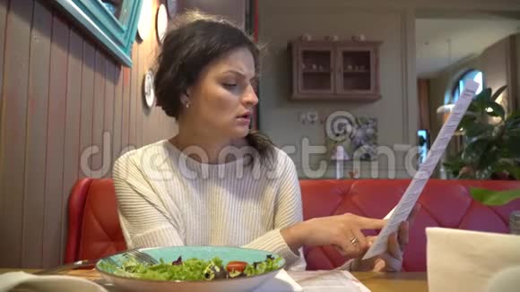 女人正在看餐厅的菜单视频的预览图