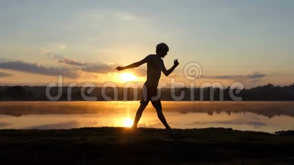 日落时分年轻人在湖边跳舞会视频的预览图